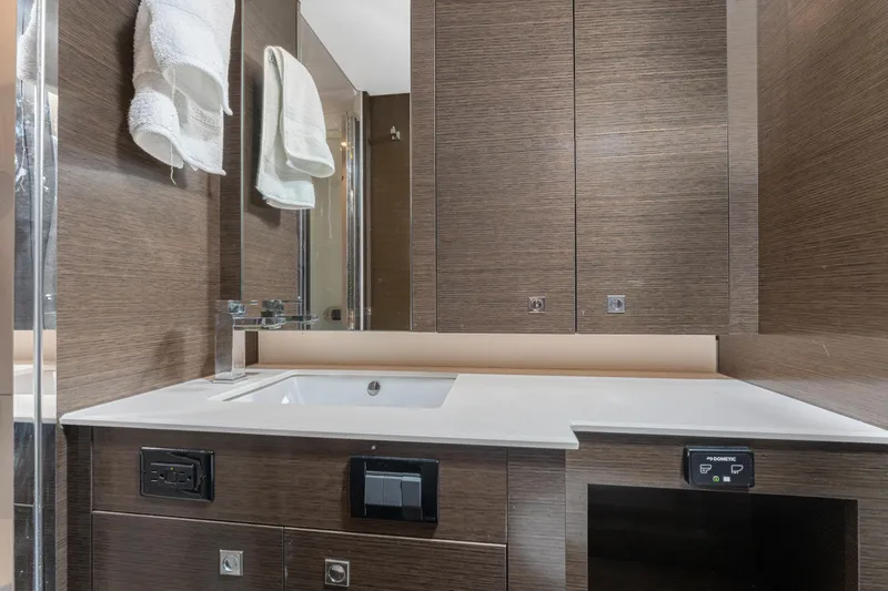 Lil' Darlin' Yacht Photos Pics Luxurious bathroom interior of 2018 Cruisers Yachts 50 Cantius with modern fixtures.