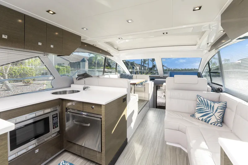 Lil' Darlin' Yacht Photos Pics Luxurious interior of 2018 Cruisers Yachts 50 Cantius with modern kitchen and seating area.