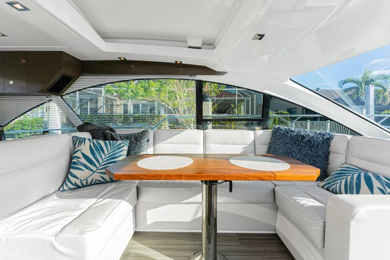 Lil' Darlin' Yacht Photos Pics Luxurious interior of 2018 Cruisers Yachts 50 Cantius with elegant seating and table.