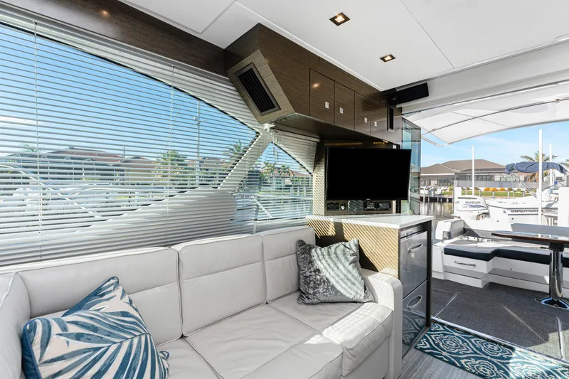 Lil' Darlin' Yacht Photos Pics Luxurious interior of 2018 Cruisers Yachts 50 Cantius with modern decor and marina view.