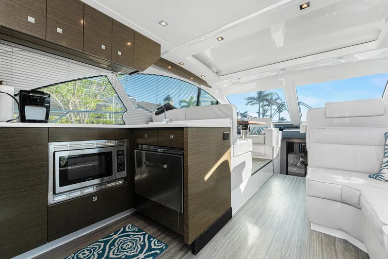 Lil' Darlin' Yacht Photos Pics Luxurious interior of 2018 Cruisers Yachts 50 Cantius with modern kitchen and seating area.