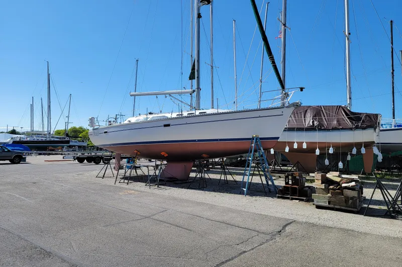 Alize Yacht Photos Pics 1999 Catalina 400 sailboat on stands in a marina, clear blue sky background.