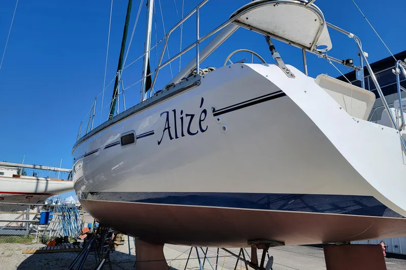 Alize Yacht Photos Pics Catalina 400 sailboat from 1999 named "Aliz&eacute;" on dry dock under clear blue sky.