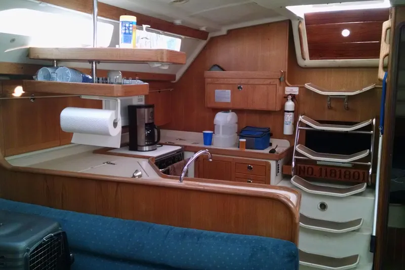 Alize Yacht Photos Pics Interior of a 1999 Catalina 400 sailboat kitchen with wooden cabinetry and appliances.