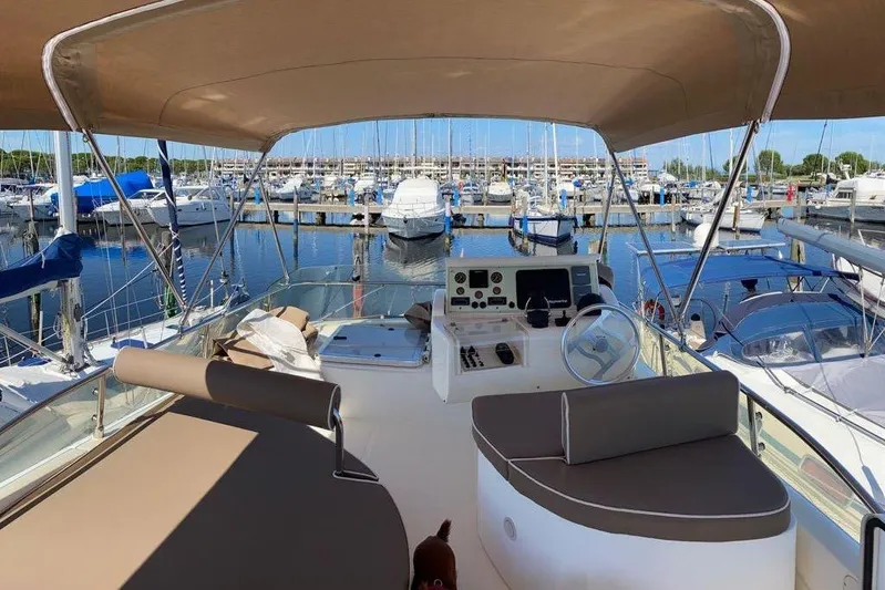  Yacht Photos Pics Flybridge of 2002 Ferretti Yachts 430, docked at marina with canopy and seating.