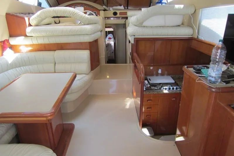  Yacht Photos Pics Luxurious interior of 2002 Ferretti Yachts 430 with elegant seating and compact kitchen.