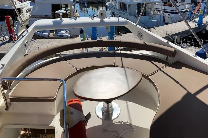  Yacht Photos Pics Flybridge seating area on a 2002 Ferretti Yachts 430, docked at a marina.