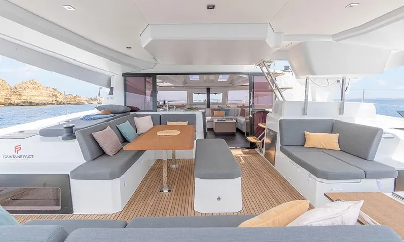  Yacht Photos Pics 2024 Fountaine Pajot Catamaran Elba 45 interior with modern seating and ocean view.