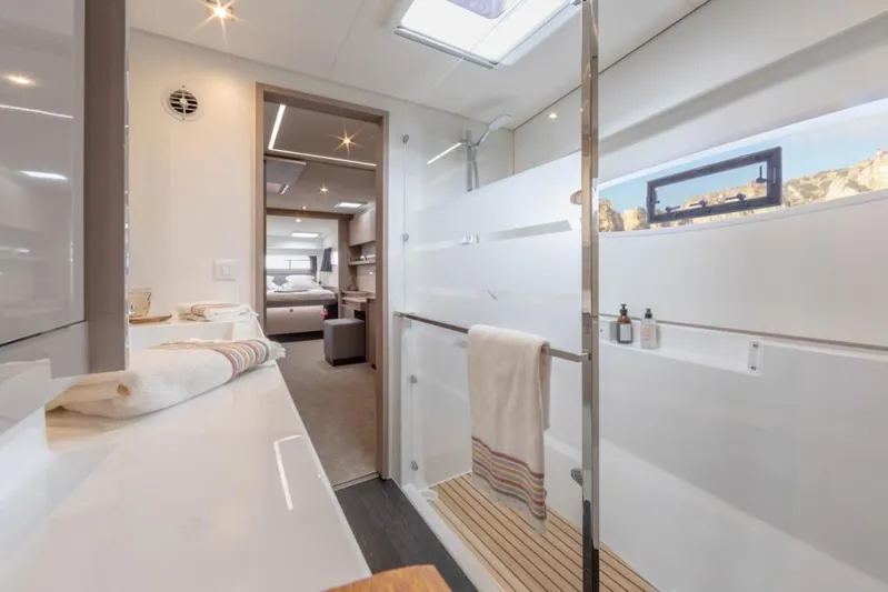  Yacht Photos Pics Luxurious interior of 2024 Fountaine Pajot Catamaran Elba 45, featuring modern bathroom design.