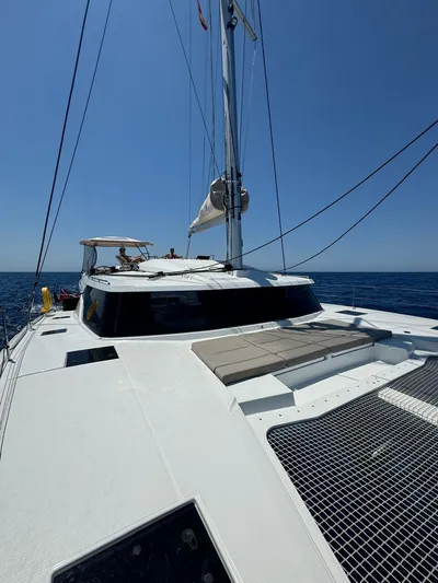  Yacht Photos Pics 2024 Fountaine Pajot Catamaran Elba 45 sailing on open sea under clear blue sky.