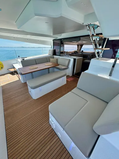  Yacht Photos Pics 2024 Fountaine Pajot Catamaran Elba 45 interior with modern seating and dining area.