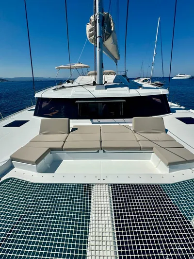  Yacht Photos Pics 2024 Fountaine Pajot Catamaran Elba 45 on open water, featuring spacious deck and seating.