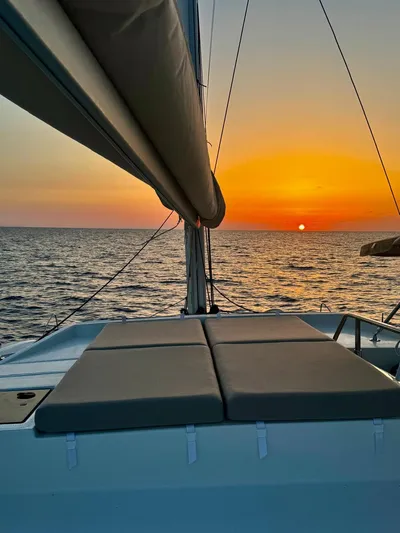  Yacht Photos Pics 2024 Fountaine Pajot Catamaran Elba 45 sailing at sunset on open sea.