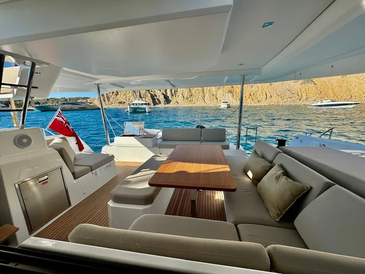  Yacht Photos Pics 2024 Fountaine Pajot Catamaran Elba 45, luxurious deck with seating, ocean view.
