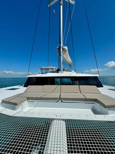  Yacht Photos Pics 2024 Fountaine Pajot Catamaran Elba 45 on open water, featuring spacious deck and netting.