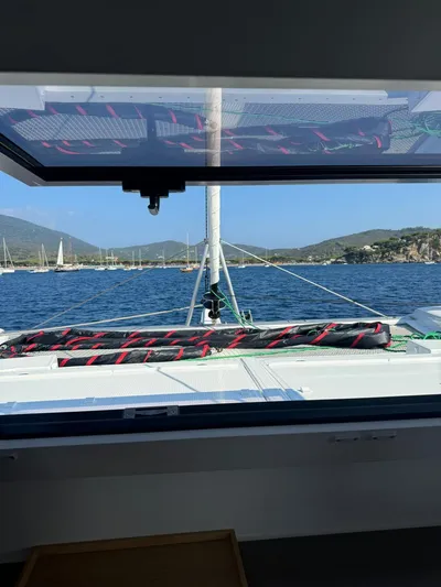  Yacht Photos Pics 2024 Fountaine Pajot Catamaran Elba 45 sailing on a serene blue sea.