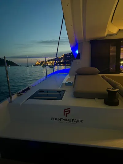 Yacht Photos Pics 2024 Fountaine Pajot Catamaran Elba 45 at sunset, featuring luxurious deck and scenic view.