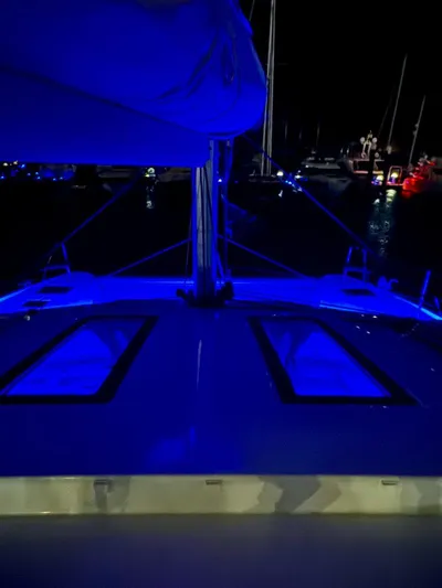  Yacht Photos Pics 2024 Fountaine Pajot Catamaran Elba 45 illuminated at night with blue lights.