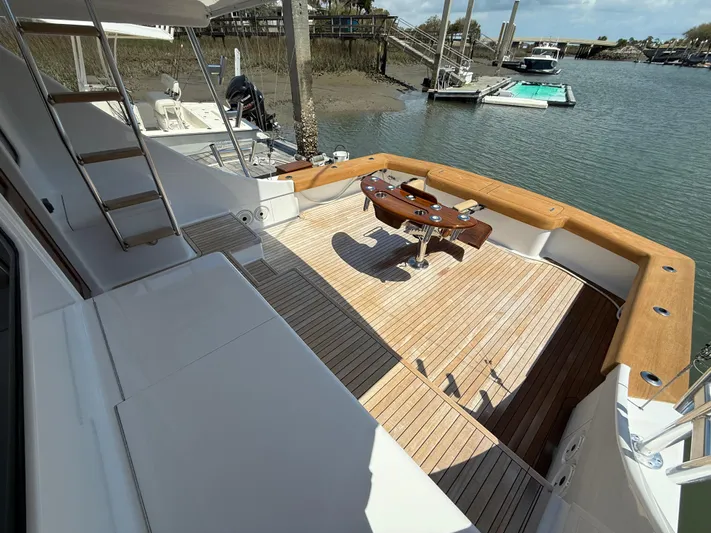 Gryphon Yacht Photos Pics Spacious deck of 2002 Custom Carolina Ritchie Howell yacht with wooden flooring and fishing chair.