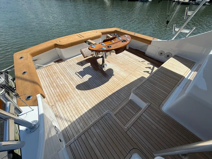 Gryphon Yacht Photos Pics Spacious deck of 2002 Custom Carolina Ritchie Howell boat with wooden flooring and fishing chair.