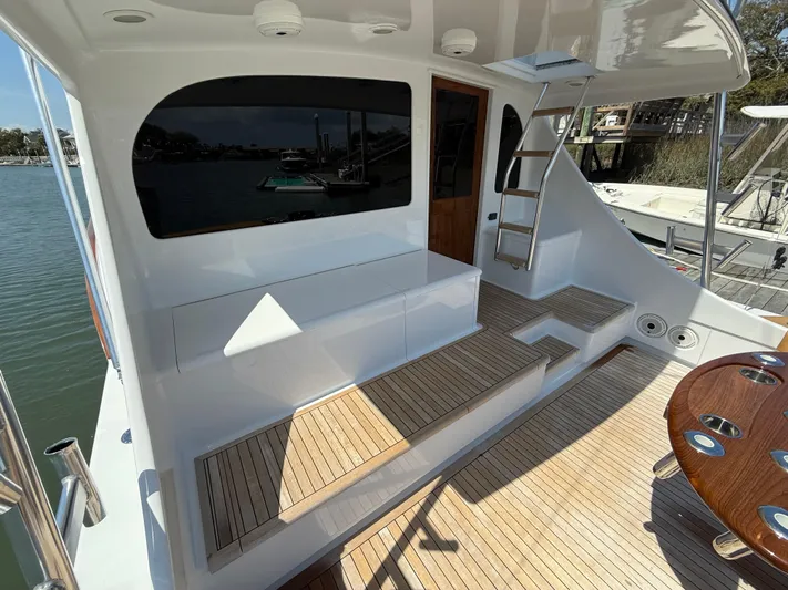 Gryphon Yacht Photos Pics Custom Carolina Ritchie Howell 2002 boat deck with seating, ladder, and wooden flooring.