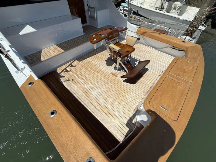 Gryphon Yacht Photos Pics Custom Carolina Ritchie Howell 2002 boat deck with wooden flooring and fishing chair.