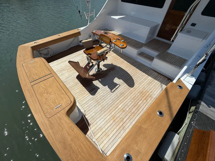 Gryphon Yacht Photos Pics Custom Carolina Ritchie Howell 2002 boat deck with fishing chair and wooden flooring.