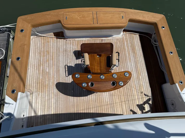 Gryphon Yacht Photos Pics Fishing deck of 2002 Custom Carolina Ritchie Howell boat with wooden chair and rod holders.