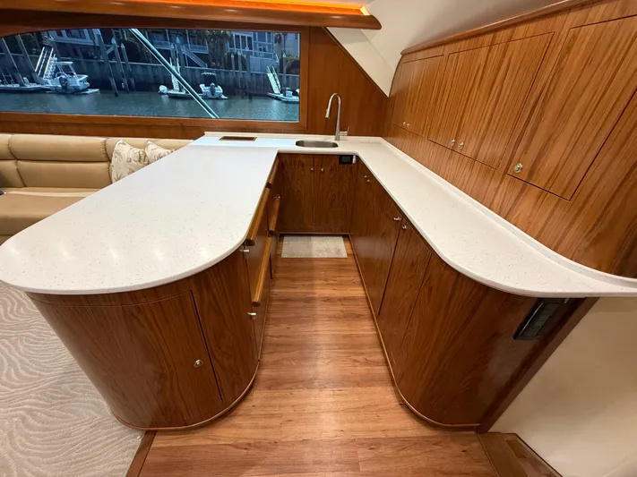 Gryphon Yacht Photos Pics Luxurious yacht kitchen with wooden cabinetry and sleek countertops, Custom Carolina Ritchie Howell 2002 model.