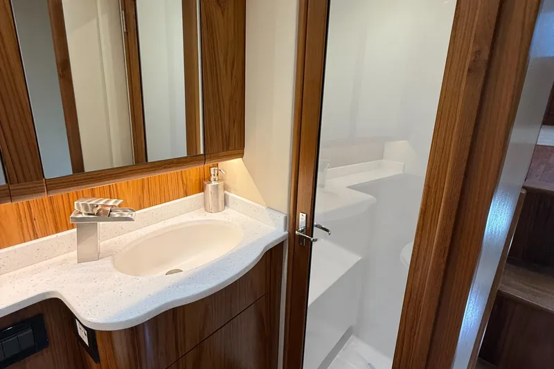 Gryphon Yacht Photos Pics Luxurious 2002 Custom Carolina Ritchie Howell yacht bathroom with modern fixtures and wood accents.