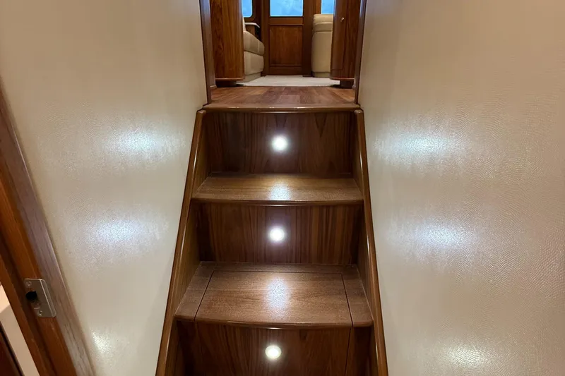 Gryphon Yacht Photos Pics Wooden staircase with built-in lights on a 2002 Custom Carolina Ritchie Howell yacht.