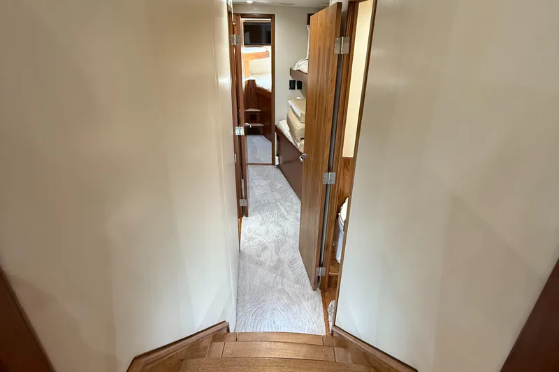Gryphon Yacht Photos Pics Hallway inside 2002 Custom Carolina Ritchie Howell yacht with wooden doors and carpeted floor.