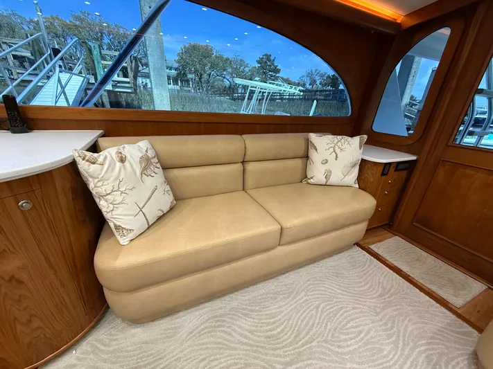 Gryphon Yacht Photos Pics Luxurious interior of 2002 Custom Carolina Ritchie Howell yacht with beige sofa and decorative pillows.