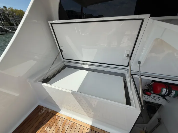 Gryphon Yacht Photos Pics Open storage compartment on 2002 Custom Carolina Ritchie Howell boat with wooden deck.