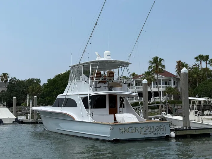 Gryphon Yacht Photos Pics Custom Carolina Ritchie Howell 2002 yacht docked, featuring sleek design and fishing equipment.