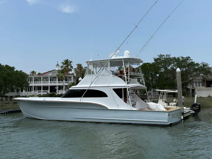 Gryphon Yacht Photos Pics Custom Carolina Ritchie Howell 2002 yacht docked by waterfront homes, clear sky.