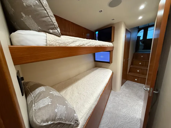 Gryphon Yacht Photos Pics Bunk beds in 2002 Custom Carolina Ritchie Howell yacht cabin with wooden accents and cozy decor.