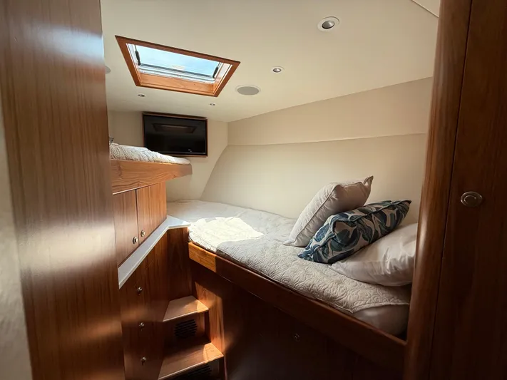 Gryphon Yacht Photos Pics Luxurious cabin interior of 2002 Custom Carolina Ritchie Howell yacht with skylight and TV.