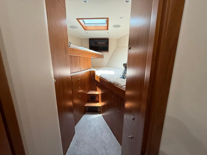 Gryphon Yacht Photos Pics Luxurious cabin interior of 2002 Custom Carolina Ritchie Howell yacht with wood finish and skylight.