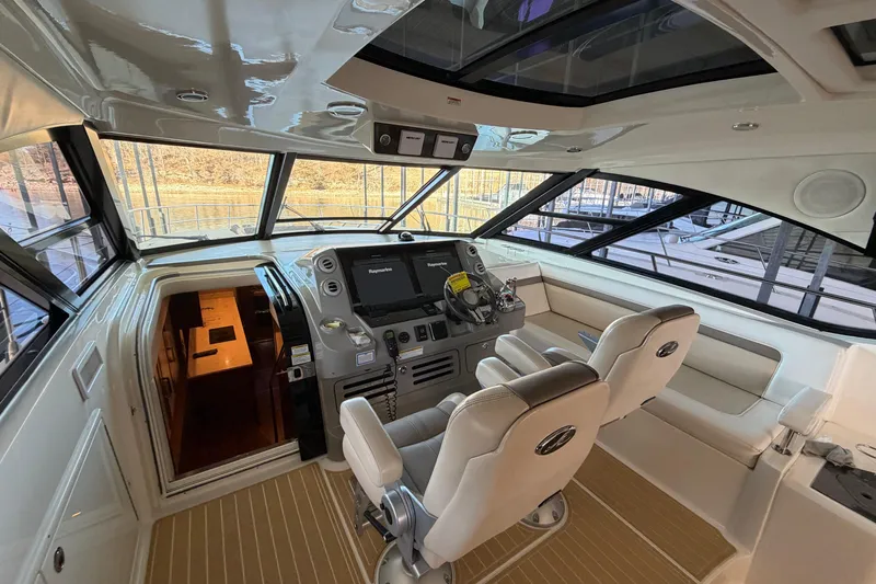  Yacht Photos Pics 2014 Sea Ray 540 Sundancer helm with dual seats and modern navigation equipment.
