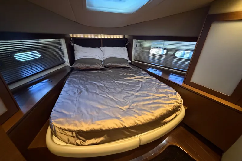  Yacht Photos Pics Luxurious bedroom interior of 2014 Sea Ray 540 Sundancer yacht with skylight and elegant bedding.