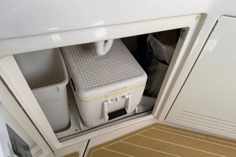  Yacht Photos Pics Storage compartment on 2014 Sea Ray 540 Sundancer with cooler and trash bin.