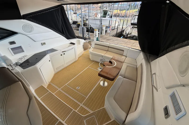 Yacht Photos Pics Luxurious interior of 2014 Sea Ray 540 Sundancer yacht with seating and table.