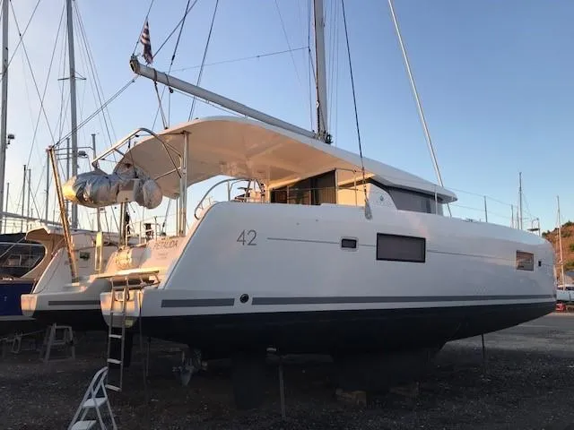 Petalida Yacht Photos Pics 2017 Lagoon 42 catamaran on dry dock, side view, with sails and equipment visible.