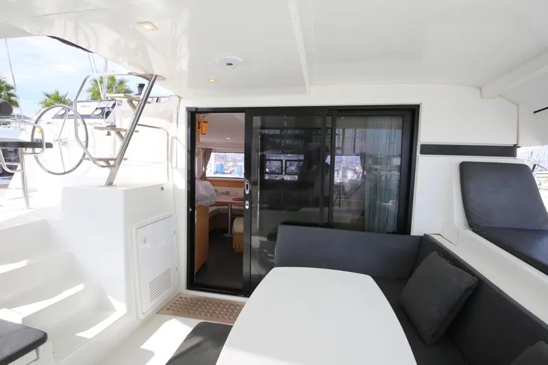 Petalida Yacht Photos Pics 2017 Lagoon 42 catamaran interior with seating area, sliding glass door, and helm station.