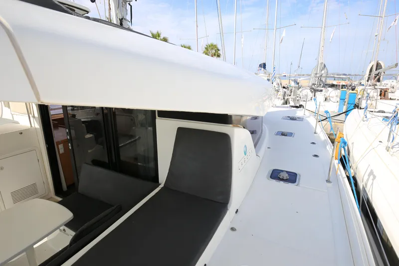 Petalida Yacht Photos Pics 2017 Lagoon 42 catamaran deck with seating, docked at marina.