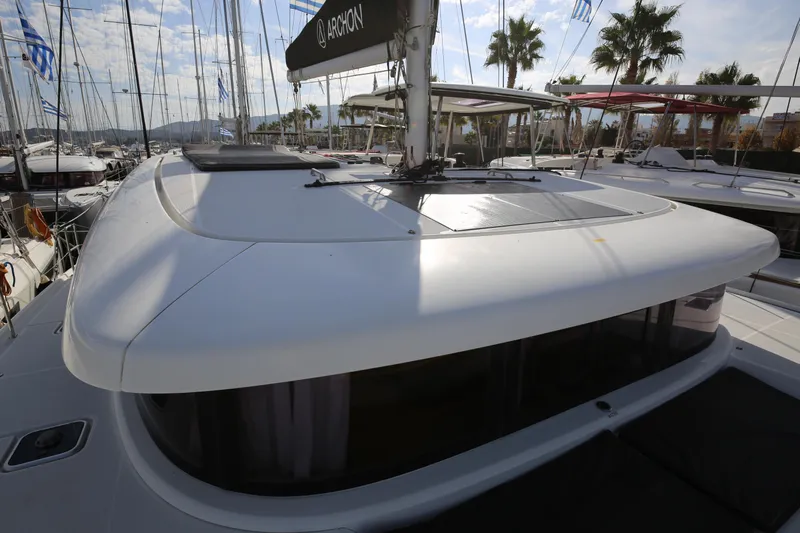 Petalida Yacht Photos Pics 2017 Lagoon 42 catamaran with sleek design, docked under a sunny sky.