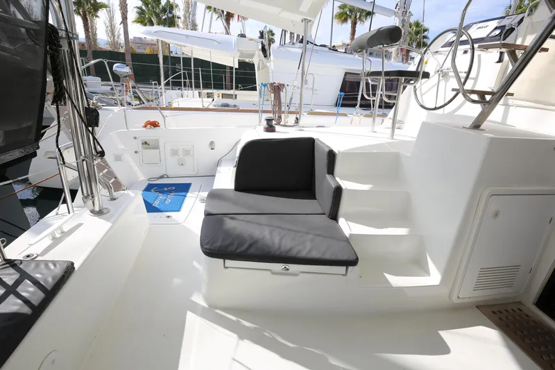 Petalida Yacht Photos Pics 2017 Lagoon 42 yacht cockpit with seating and steering wheel, docked at marina.