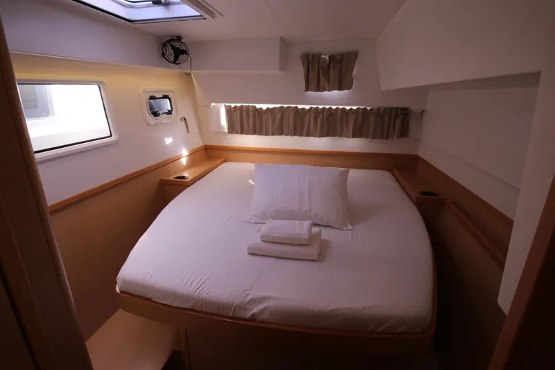 Petalida Yacht Photos Pics Cozy bedroom in 2017 Lagoon 42 yacht with natural light and comfortable bedding.