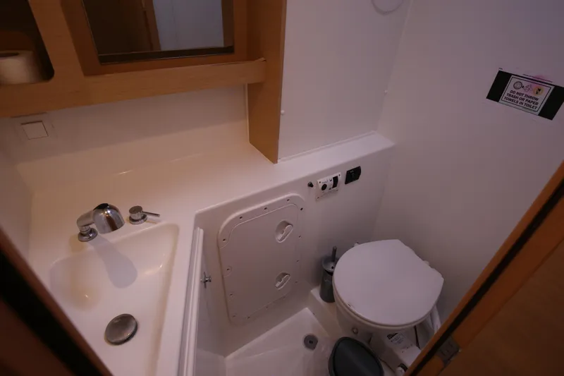 Petalida Yacht Photos Pics Compact bathroom in 2017 Lagoon 42 catamaran with sink, toilet, and storage.
